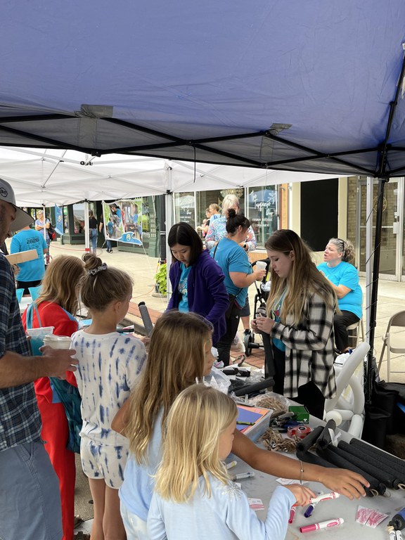 Wave students helping kids make foam rockets