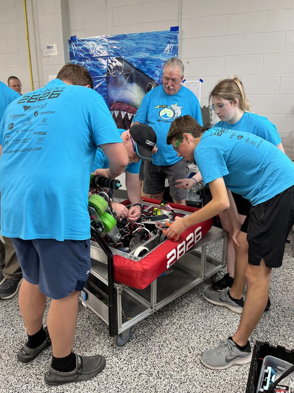 Students and Mentors working on the robot in the pits